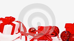 Xmas sale. White gift with red color bow, balls and in Christmas decoration on white background for greeting card. Christmas,