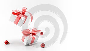 Xmas sale. White gifts with red ribbon and New Year balls in Christmas decoration on white background for greeting card. Xmas