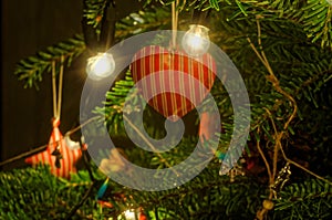 Xmas tree red heart decoration hanging on tree.