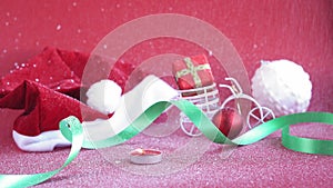 Xmas, winter, happy new year concept - red Christmas background cover with white snow falls on Santa hat with burning