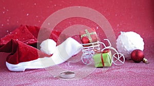 Xmas, winter, happy new year concept - red Christmas background cover with white snow Santa hat and sleigh with burning