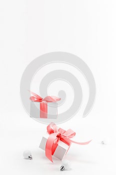 Xmas wreath. White gifts with red ribbon and New Year balls in Christmas decoration on white background for greeting card. Xmas