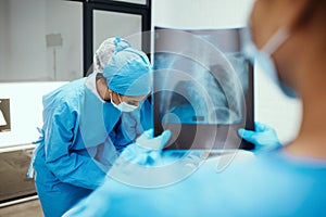 Xray, body and surgery team in hospital, consulting for cancer tumor healthcare wellness or emergency risk. Nurse photo