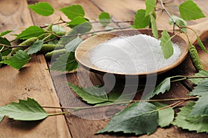 Xylit (birch sugar) on a wooden spoon