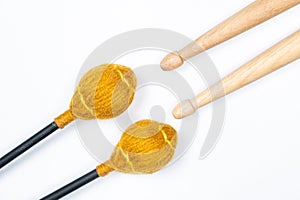 Xylophone and drum sticks on white background top view