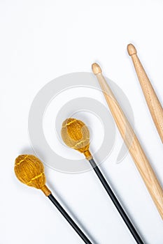 Xylophone and drum sticks on white background top view