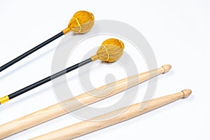 Xylophone and drum sticks on white background top view