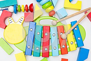 Xylophone and other wooden toys on a white background. flat lay