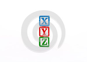 XYZ alphabets letters written on wooden cubes isolated on white background photo