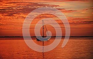 Yach on water. Boat on ocean at sunset. Sailboats with sails. Sea traveling.