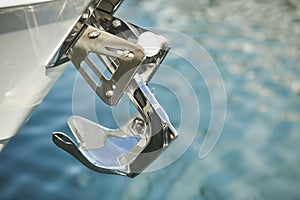 Yacht anchor close-up seen on the front of a luxury boat. Sailboat bow parked in harbor, yachting, sailing