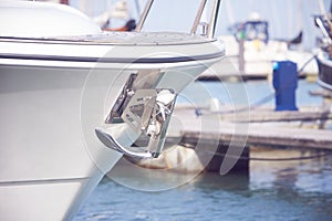 Yacht anchor close-up seen on the front of a luxury boat. Sailboat bow parked in harbor, yachting, sailing