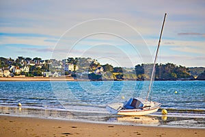 Yacht anchored on sand beach in Erquy, Brittany, France