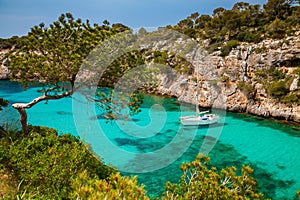 The yacht in azure sea in the village Cala Pi