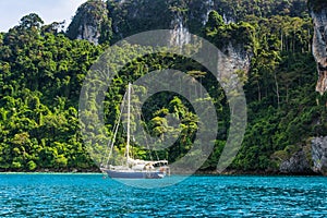 Yacht in beautiful bay near Koh Phi Phi Don in Andaman sea. Location: island Koh Phi Phi Don, Krabi, South Thailand. Artistic pi