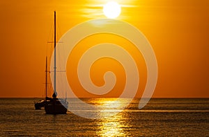 Yacht boat sailing boats or Travel boats in Beautiful phuket sea at sunset golden sky Amazing for summer holiday background and