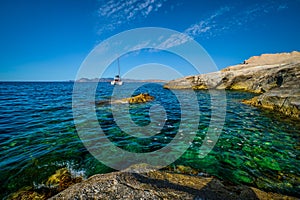 Yacht boat at Sarakiniko Beach in Aegean sea, Milos island , Greece