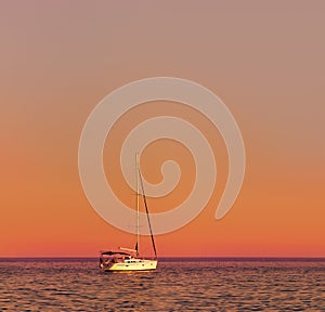Yacht in a calm sea, a beautiful sunset, the calm. Waves.Beautiful photo.