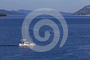 yacht cruises on the Adriatic Sea in the region of Dubrovnik, Croatia, with islands in the background, sunny day, clear weather,