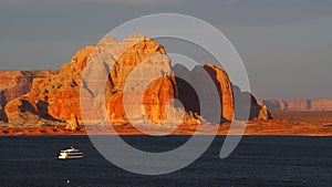 A yacht cruises through Lake Powell at Sunset