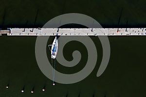Yacht in the dock from above on a dark water background