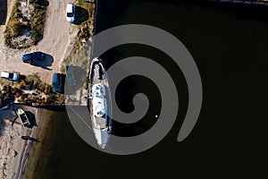 Yacht in the dock from above on a dark water background