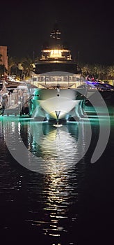 Yacht docked in light with colorful lights in Bahamas