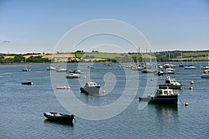 Yacht and fishing boats lies peacefully at anchor in a sheltered