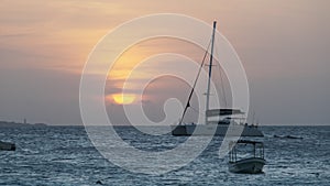 Yacht with a High Mast Sailing at Sunset in the Ocean, Zanzibar, Africa