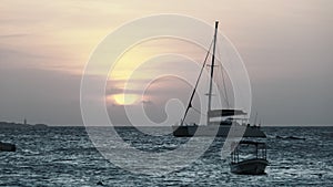 Yacht with a High Mast Sailing at Sunset in the Ocean, Zanzibar, Africa