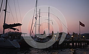 Yacht and jetty silhouettes at dawn