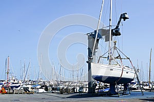 The yacht lifted ashore by a sailboat lift for the maintenance of the underwater part of the hull