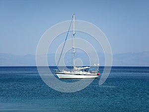 Yacht in light blue aegean sea