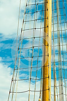 Yacht mast against blue summer sky. Yachting