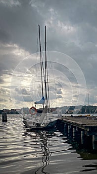 Yacht moored by pier