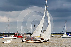 Yacht navigating the river under sail