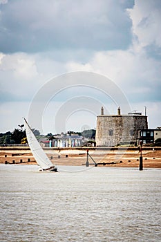 Yacht navigating the river under sail