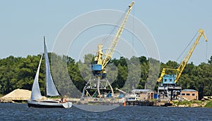 Yacht near a crane at the port
