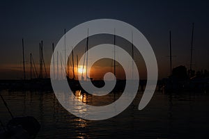 Yacht Parking at sunset with the reflection of masts in the water