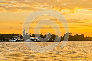 Yacht at the pier at sunset on summer evening