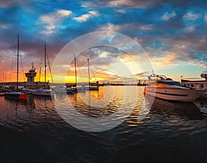 Yacht port and beautiful sunset over Varna, Bulgaria. Sailboat harbor, many beautiful moored sail yachts in the sea