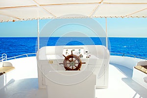 Yacht`s steering wheel sails on the sea