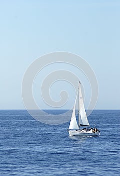 Yacht with sail cruising photo