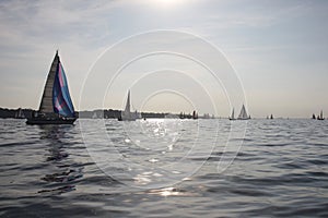 Yacht sailboats sailing on a calm sunny day on the solent photo