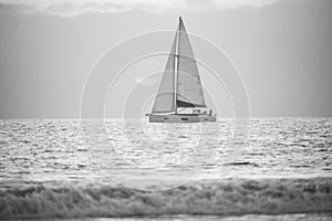 Yacht sailing against sunset. Landscape with skyline sailboat and sunset silhouette. Yachting tourism. Romantic trip on