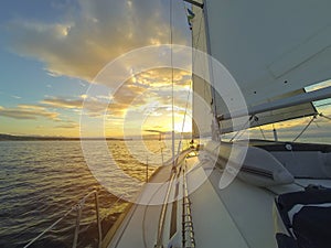 Yacht Sailing against sunset.Sailboat