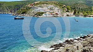 Yacht sailing boat in mediterranean sea bay near greece assos village on kefalonia island shore in background. Travel