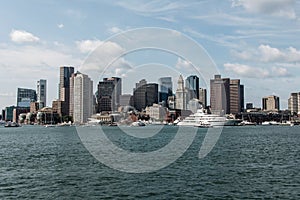 Yacht and sailing boats on Charles River in front of Boston Skyline in Massachusetts USA on a sunny summer day