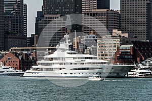 Yacht and sailing boats on Charles River in front of Boston Skyline in Massachusetts USA on a sunny summer day