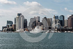 Yacht and sailing boats on Charles River in front of Boston Skyline in Massachusetts USA on a sunny summer day